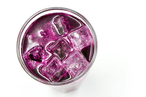 Top-down shot of a refreshing purple drink filled with ice cubes, perfect for a cooling refreshment.