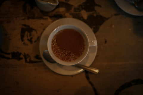 Warm and moody image of a tea cup on a rustic table, perfect for cozy themes.