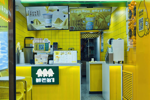 Bright and lively bubble tea shop interior with vibrant yellow decor in Hohhot, China.