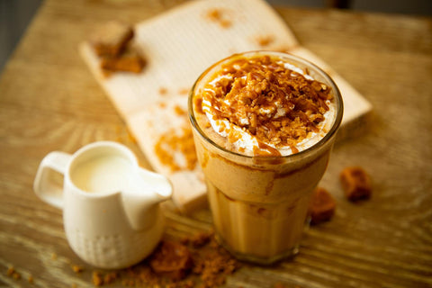 A refreshing iced coffee topped with caramel and cream serves as a delicious treat for coffee lovers.