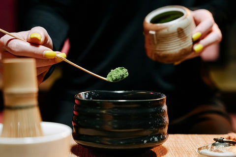 Close-up of a traditional matcha tea ceremony, highlighting the preparation process and cultural significance.